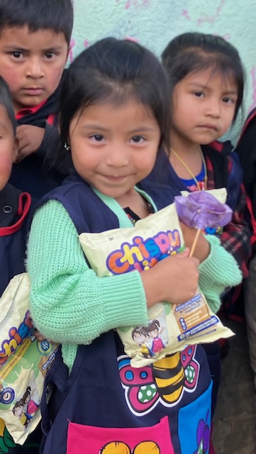 A young girl in rural Guatemala holding food
